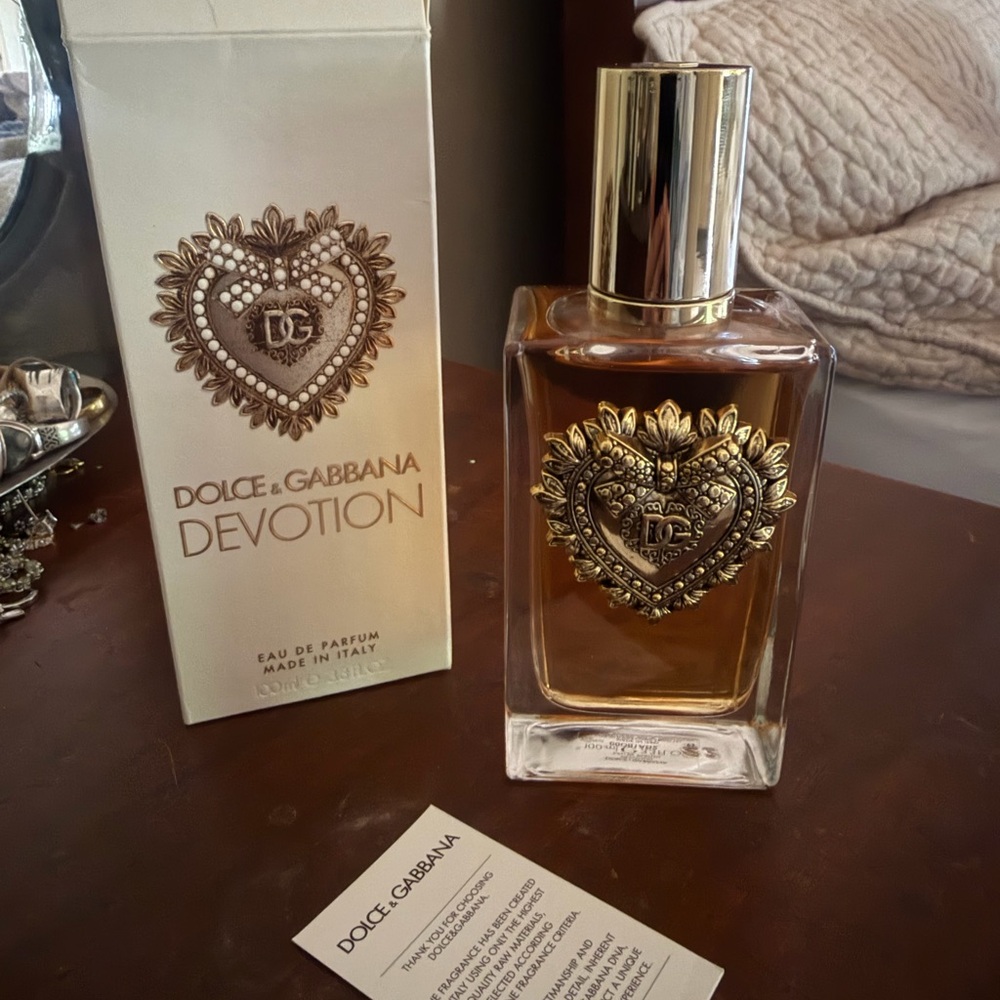 Dolce & Gabbana Devotion perfume bottle in gold and amber tones